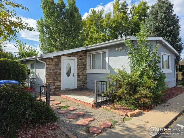 a front view of house with yard and trees around