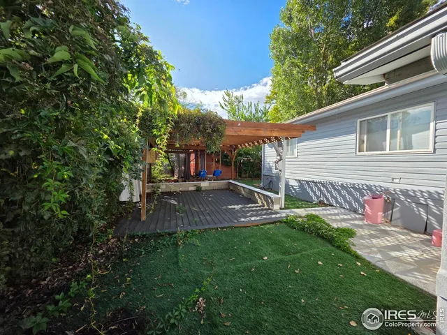 a view of backyard with a garden and deck