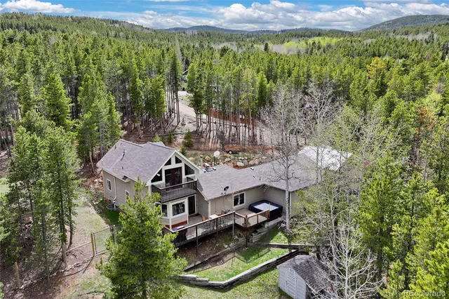 an aerial view of a house with a yard basket ball court and outdoor seating