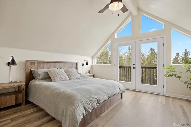 a bedroom with a large bed and a chandelier