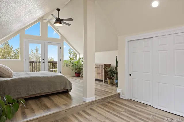 a bedroom with a balcony a bed and a chandelier