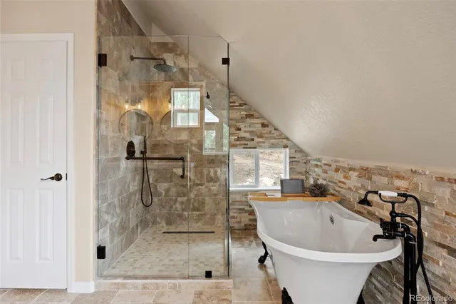 a bathroom with a bathtub and shower