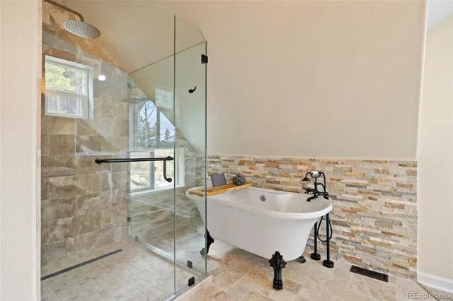 a spacious bathroom with a shower and bathtub