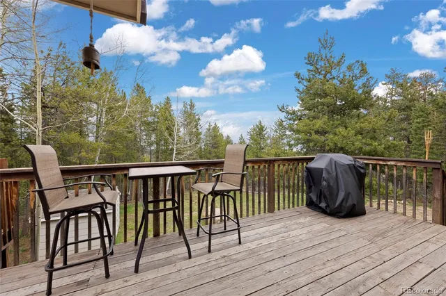 a view of a balcony with wooden floor and outdoor seating