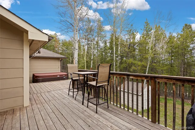 a view of a deck with table and chairs and wooden floor