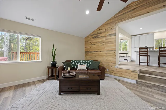 a living room with furniture and large windows