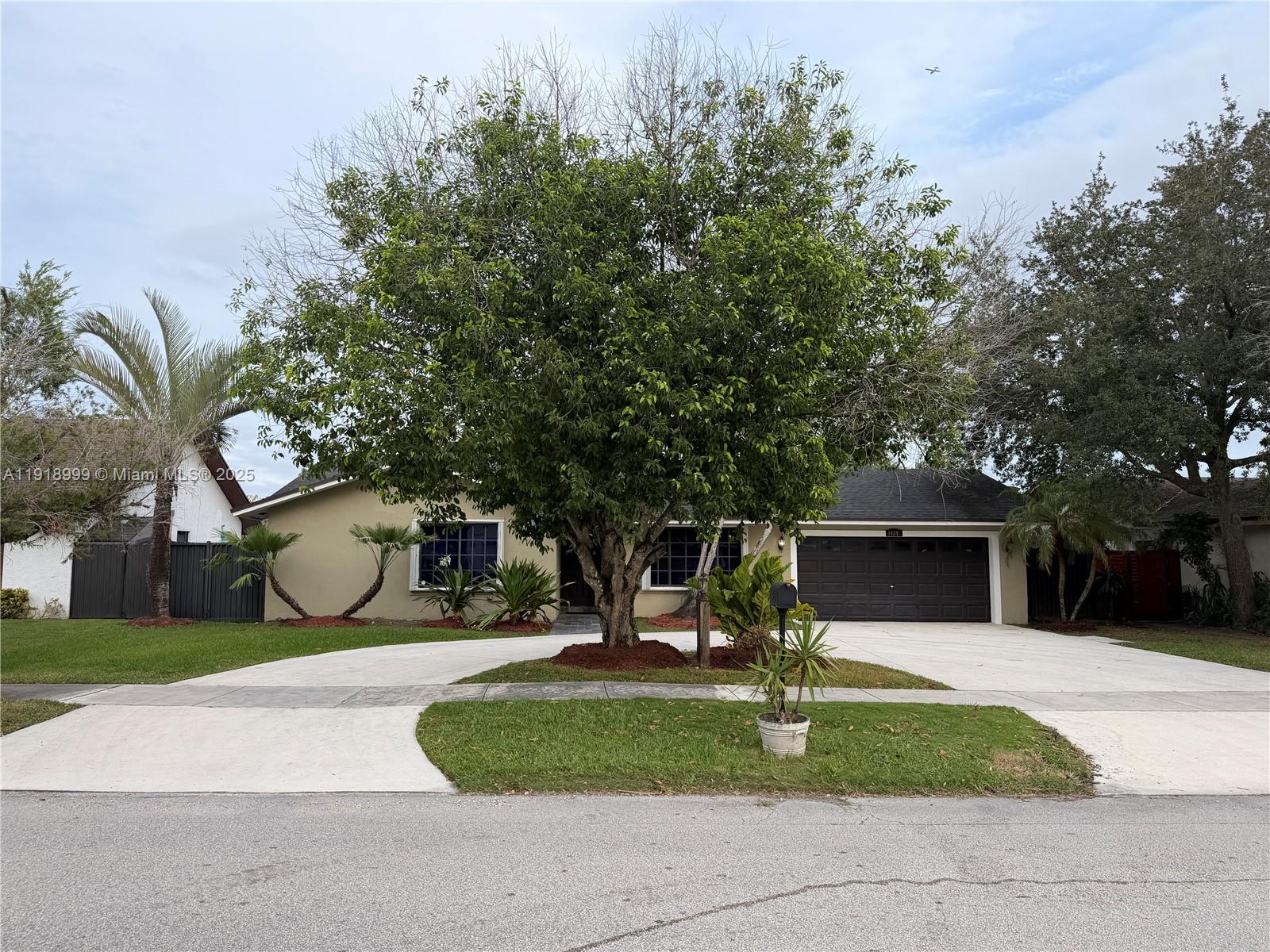 10241 Southwest 132nd Avenue Miami, FL 33186 - Photo 1 of 26 a house with trees in front of it