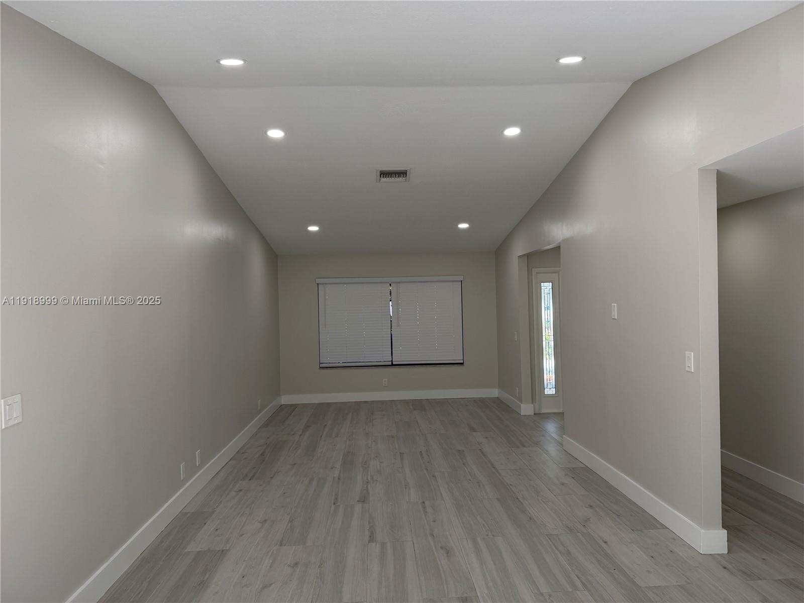 10241 Southwest 132nd Avenue Miami, FL 33186 - Photo 11 of 26 an empty room with wooden floor and windows