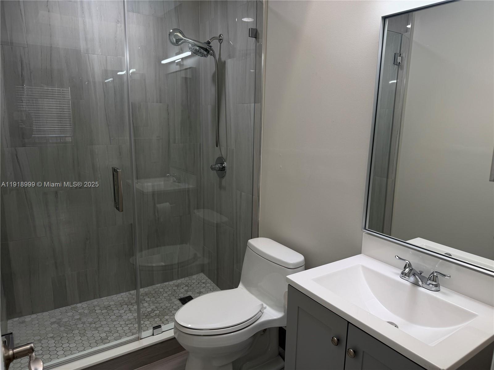 10241 Southwest 132nd Avenue Miami, FL 33186 - Photo 12 of 26 a bathroom with a sink toilet and shower