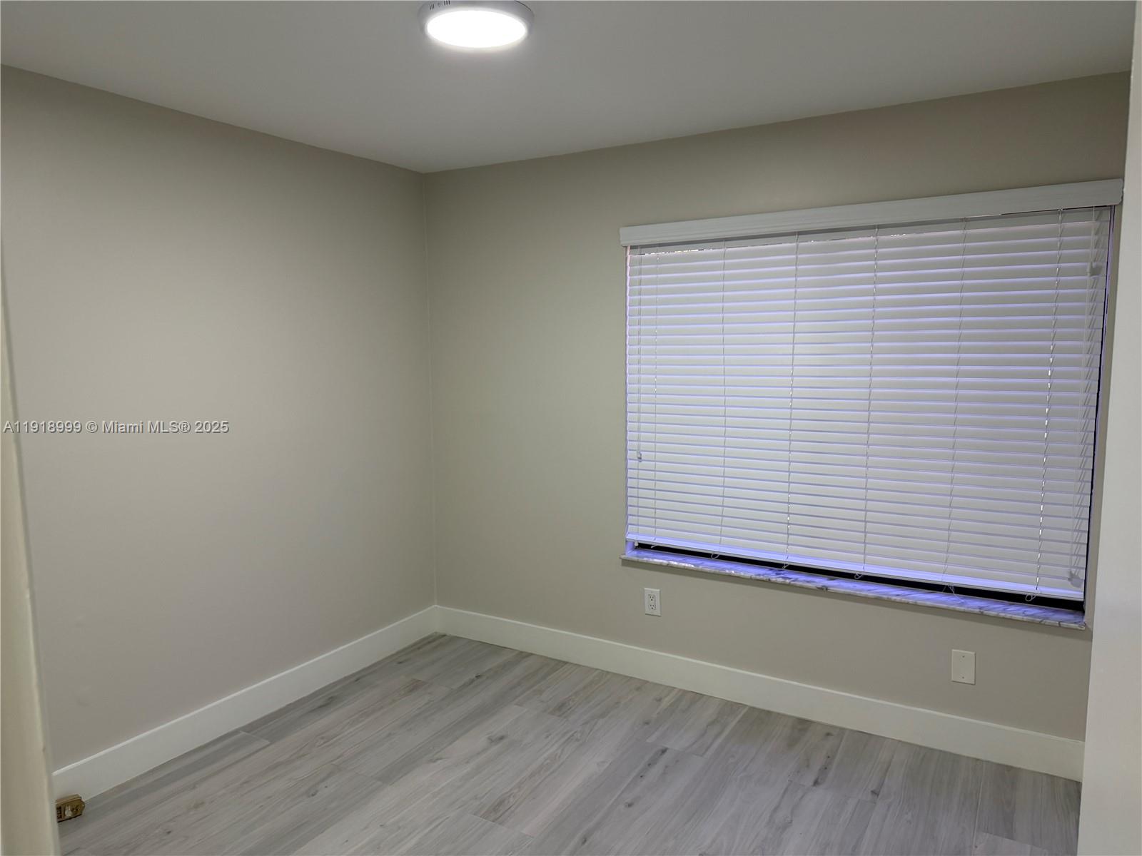 10241 Southwest 132nd Avenue Miami, FL 33186 - Photo 13 of 26 a view of a small space with wooden floor and a window