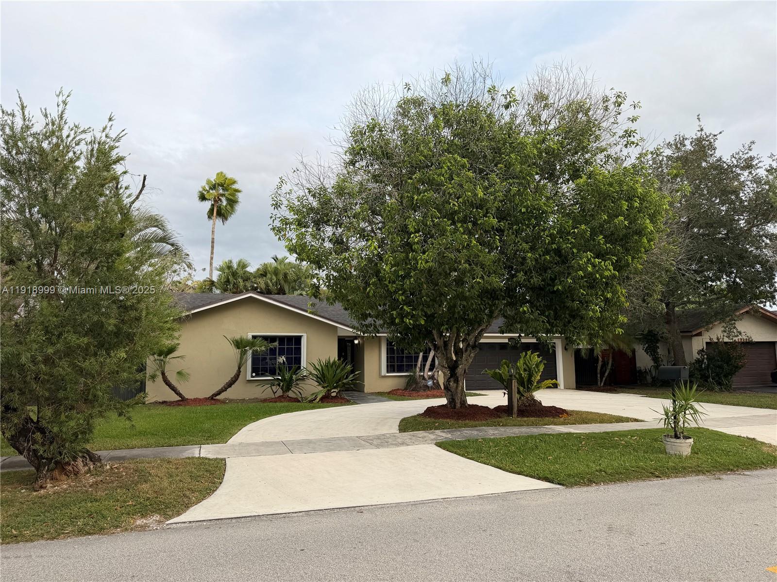 10241 Southwest 132nd Avenue Miami, FL 33186 - Photo 2 of 26 a front view of a house with garden