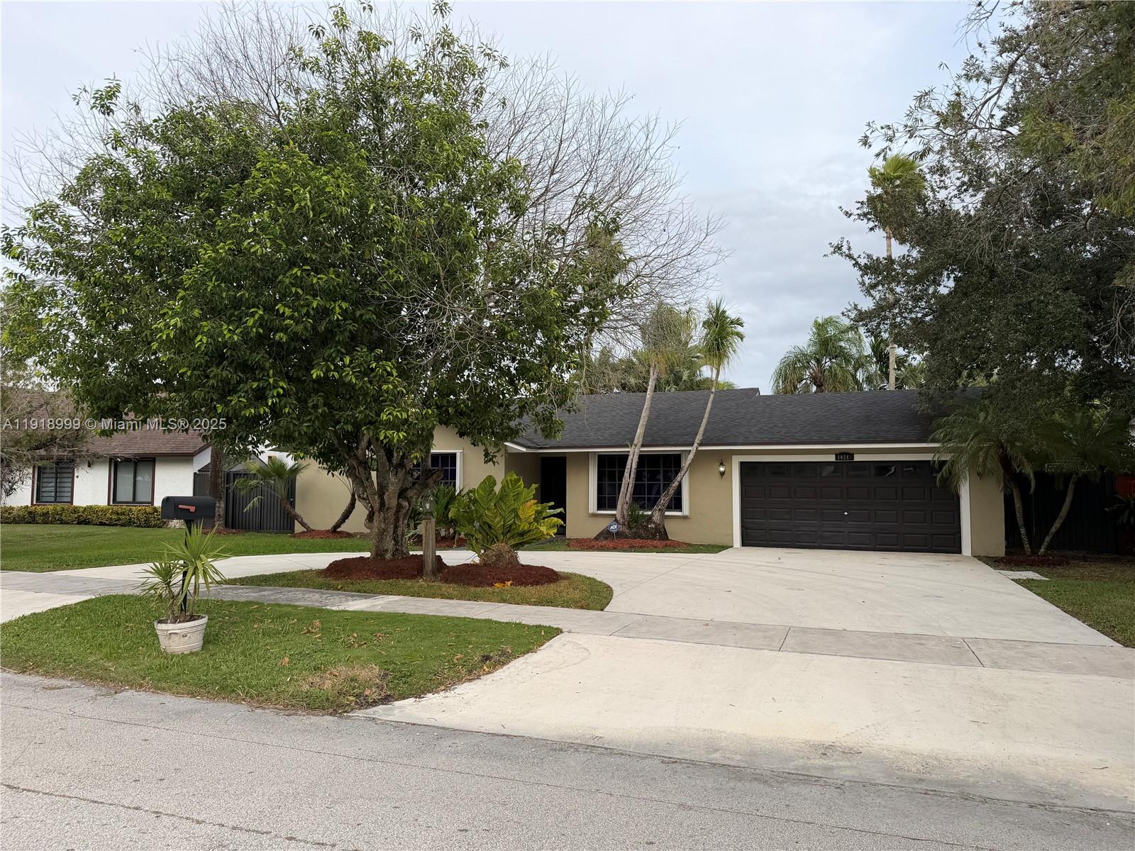 10241 Southwest 132nd Avenue Miami, FL 33186 - Photo 3 of 26 a view of a house with backyard and trees