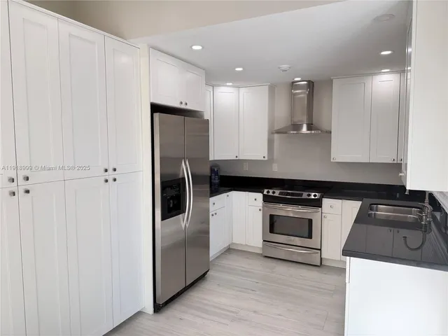 a kitchen with a refrigerator stove and sink