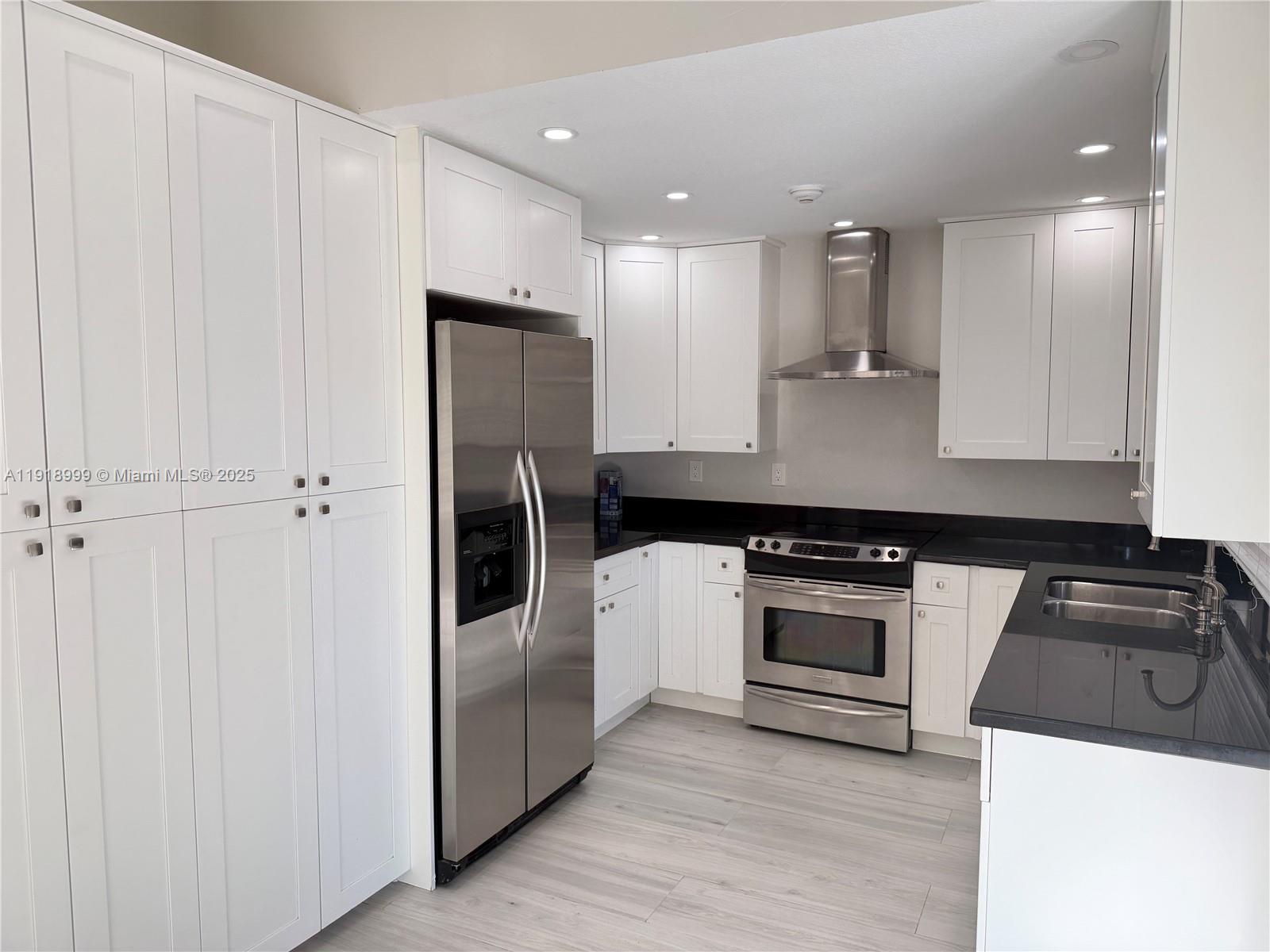 10241 Southwest 132nd Avenue Miami, FL 33186 - Photo 5 of 26 a kitchen with a refrigerator stove and sink