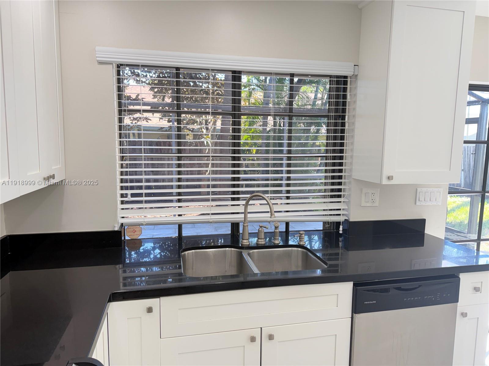 10241 Southwest 132nd Avenue Miami, FL 33186 - Photo 7 of 26 a kitchen with granite countertop a sink and a window