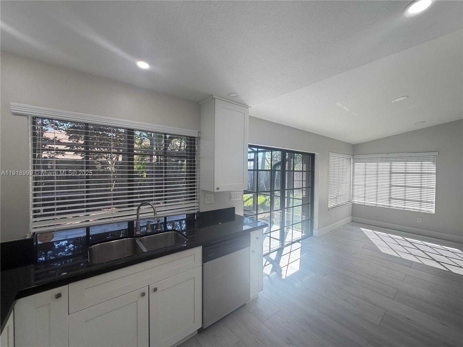 10241 Southwest 132nd Avenue Miami, FL 33186 - Photo 8 of 26 a kitchen with granite countertop a sink and a large window