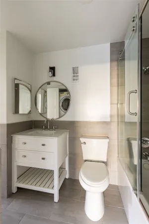 a bathroom with a toilet sink and shower