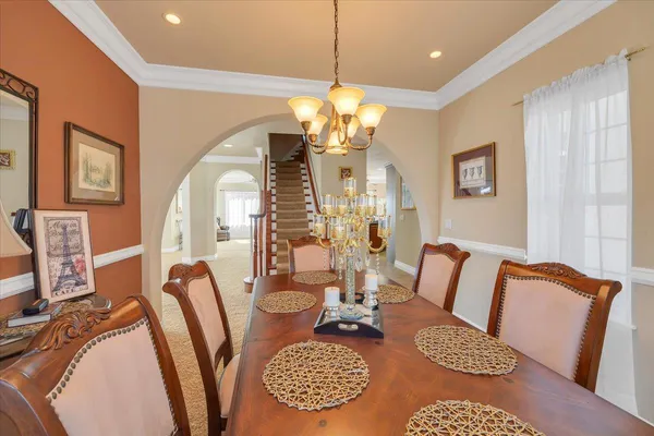 a bedroom with a bed and a lamp on dresser