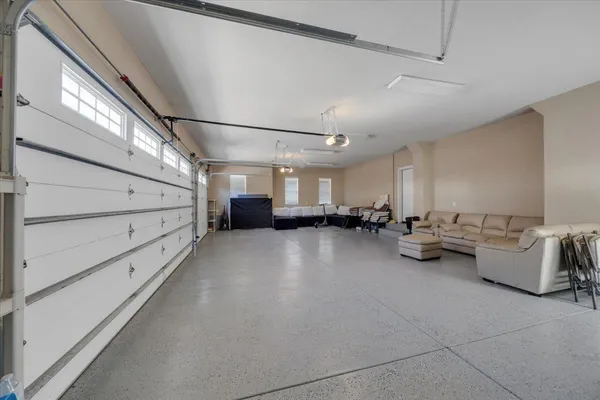 an aerial view of residential houses with outdoor space and lake view