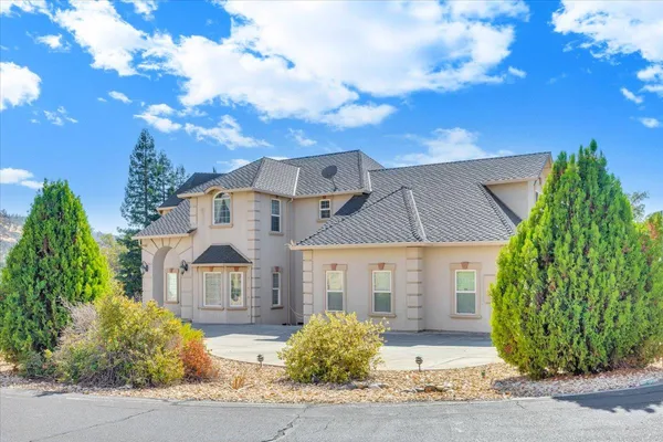 a living room with furniture a chandelier and a large window