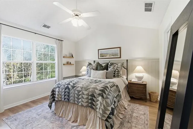 a bedroom with a bed and a window