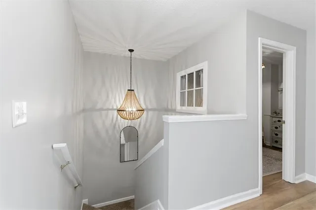 a picture of a room with wooden floor and cabinet