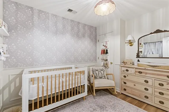 a bedroom with furniture and a large window