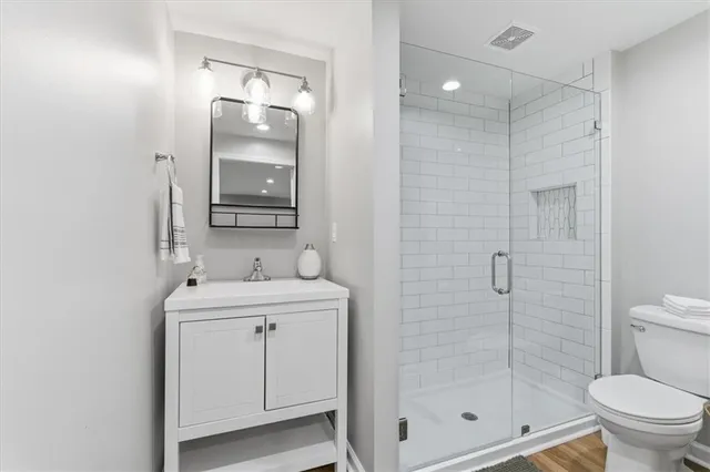 a bathroom with a toilet sink and shower