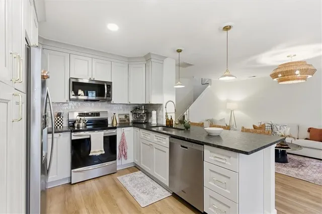 a kitchen with a sink stove and microwave