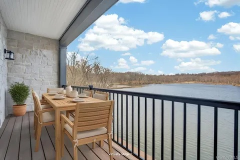 a view of a balcony with wooden floor and outdoor space