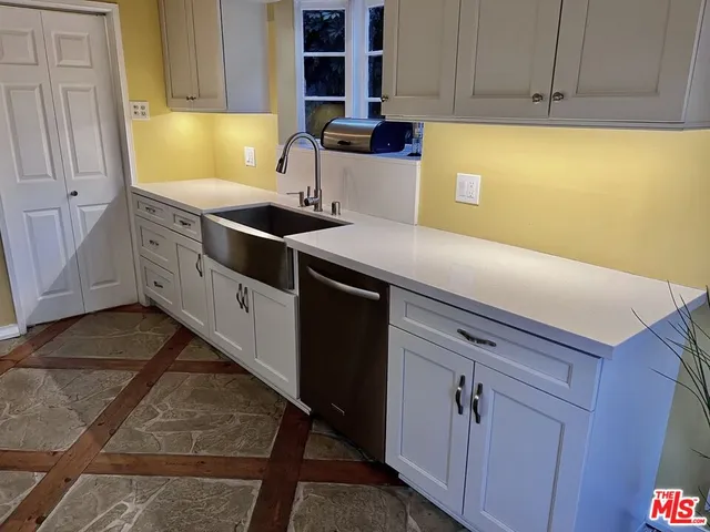 a kitchen with a sink and cabinets