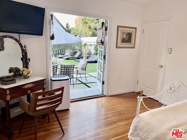 a living room with furniture a wooden floor and a window