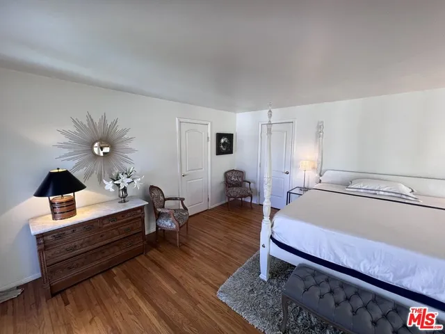 a living room with furniture a table and wooden floor