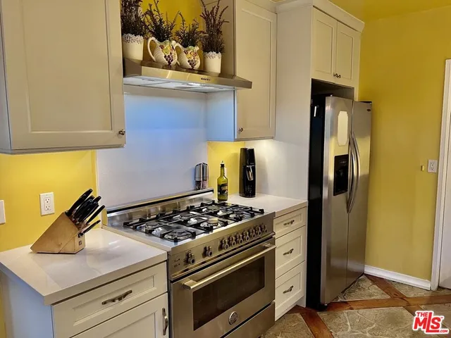 a kitchen with a stove and a refrigerator