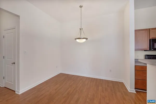 a view of a room with wooden floor and a sink