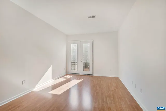 a view of an empty room and wooden floor