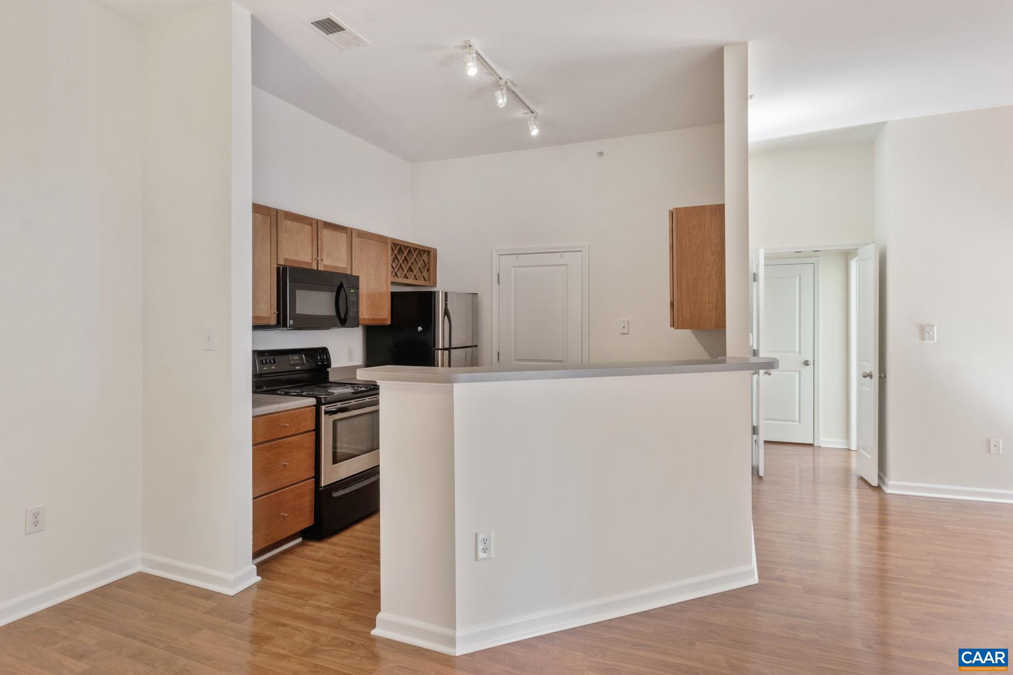 765 Walker Square, Unit 4B Charlottesville, VA 22903 - Photo 7 of 17 a view of kitchen with stainless steel appliances a refrigerator and a stove top oven