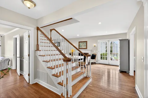 a view of entryway with wooden floor and stairs