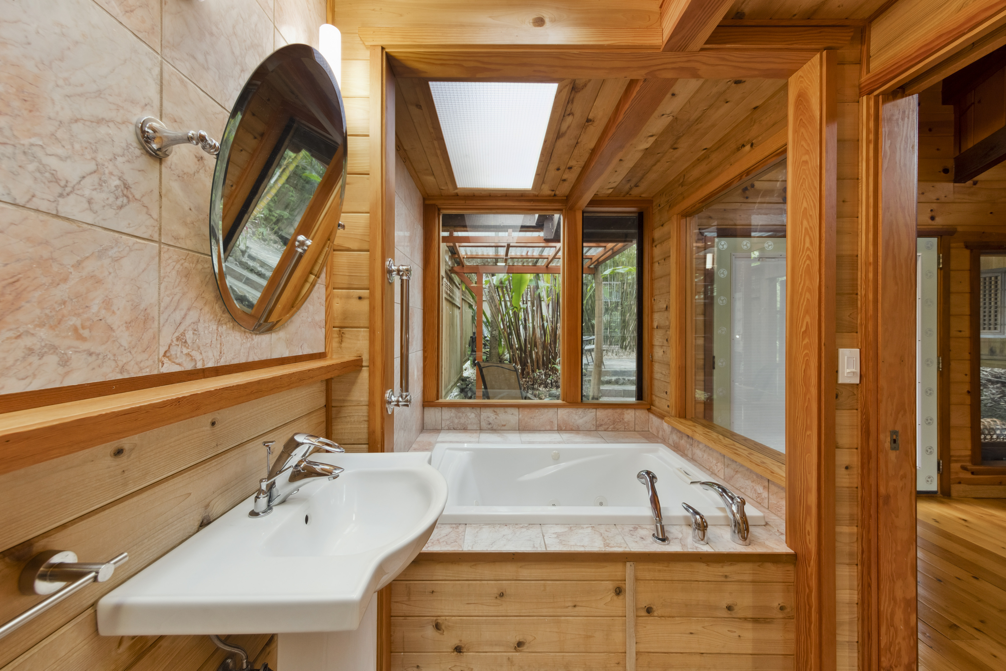 19-4245 Kekoa Nui Boulevard Volcano, HI 96785 - Photo 14 of 30 a bathroom with a tub sink and mirror