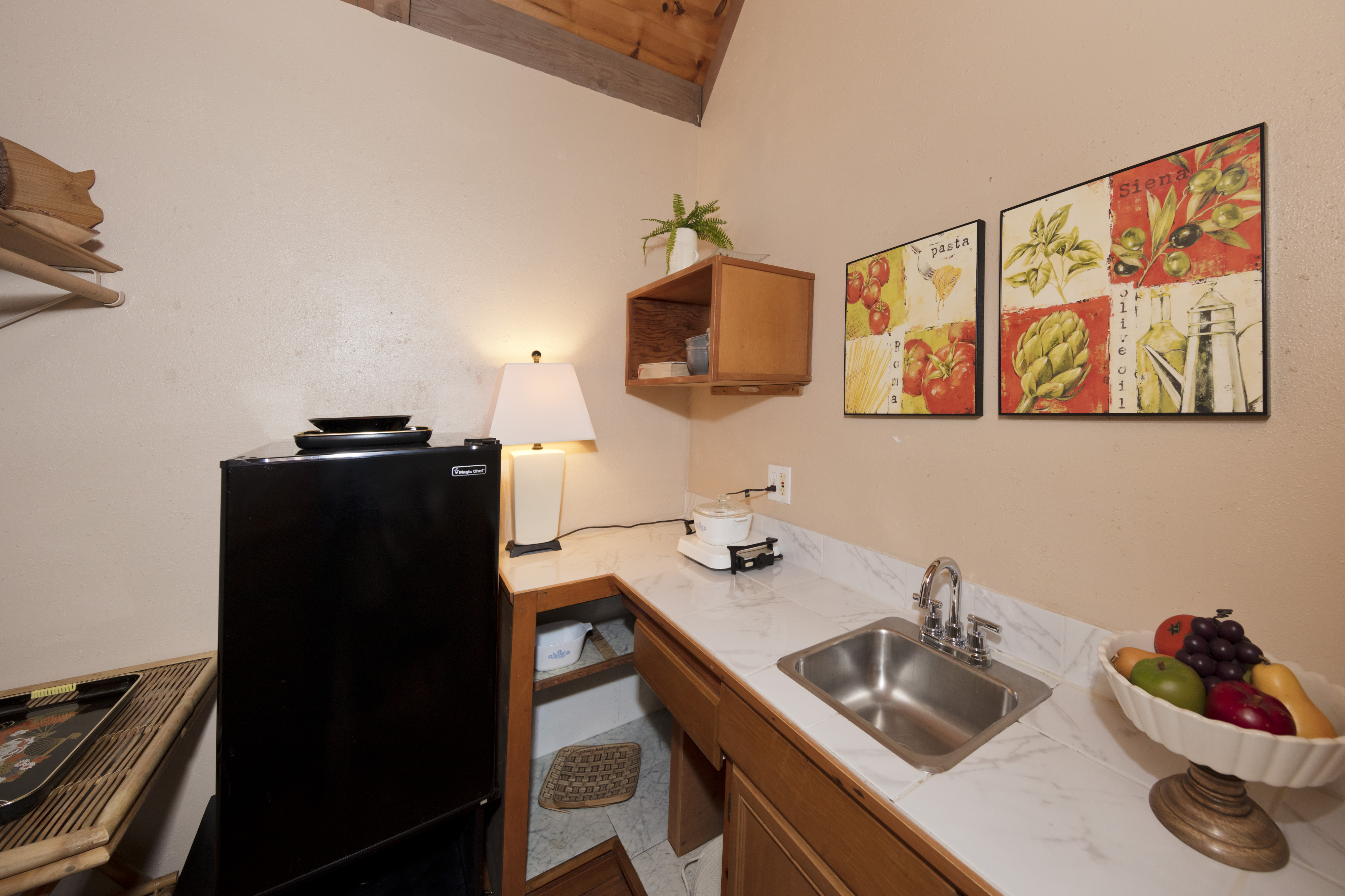 19-4245 Kekoa Nui Boulevard Volcano, HI 96785 - Photo 20 of 30 a kitchen with a sink and refrigerator