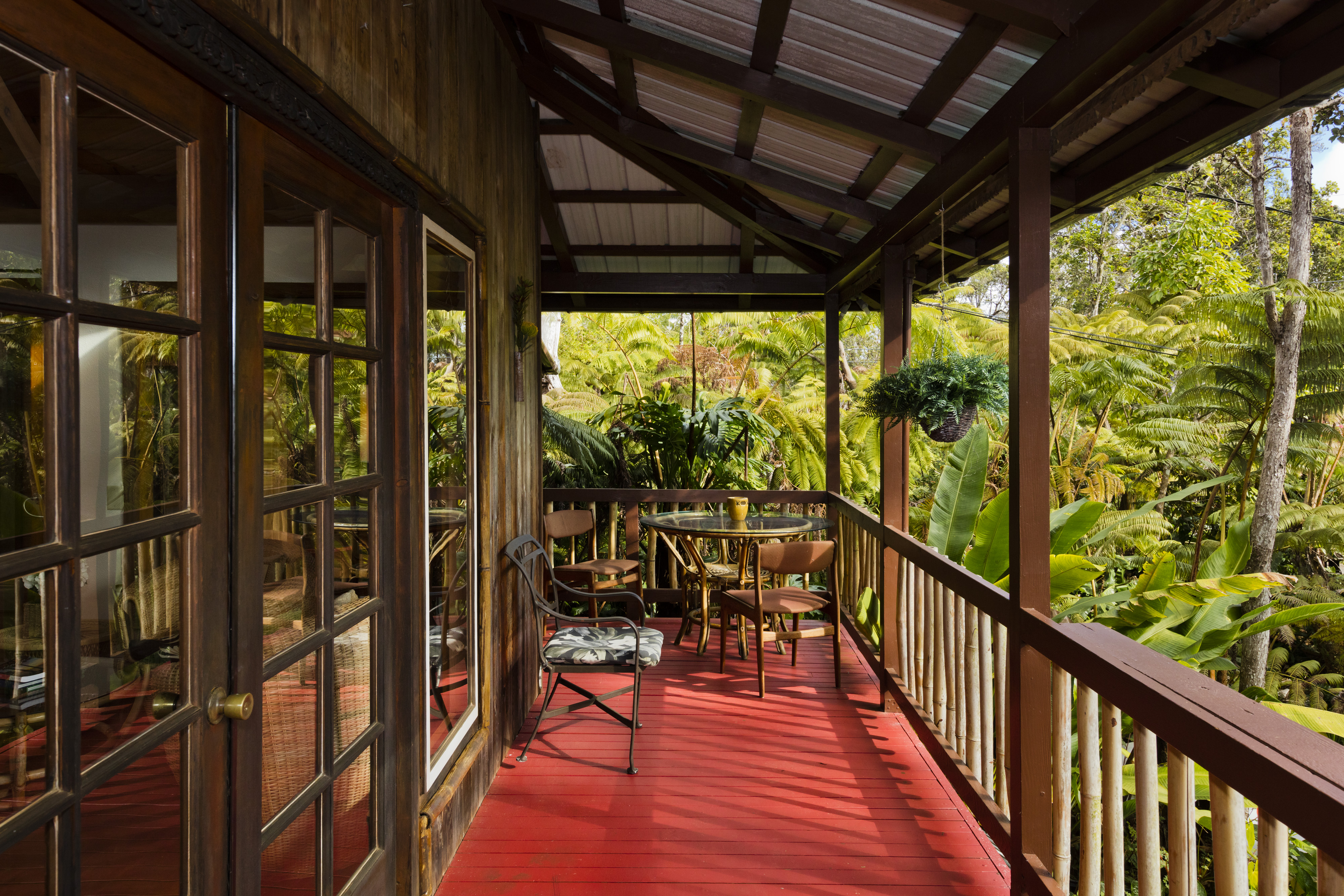 19-4245 Kekoa Nui Boulevard Volcano, HI 96785 - Photo 22 of 30 a view of a porch with chairs and wooden floor
