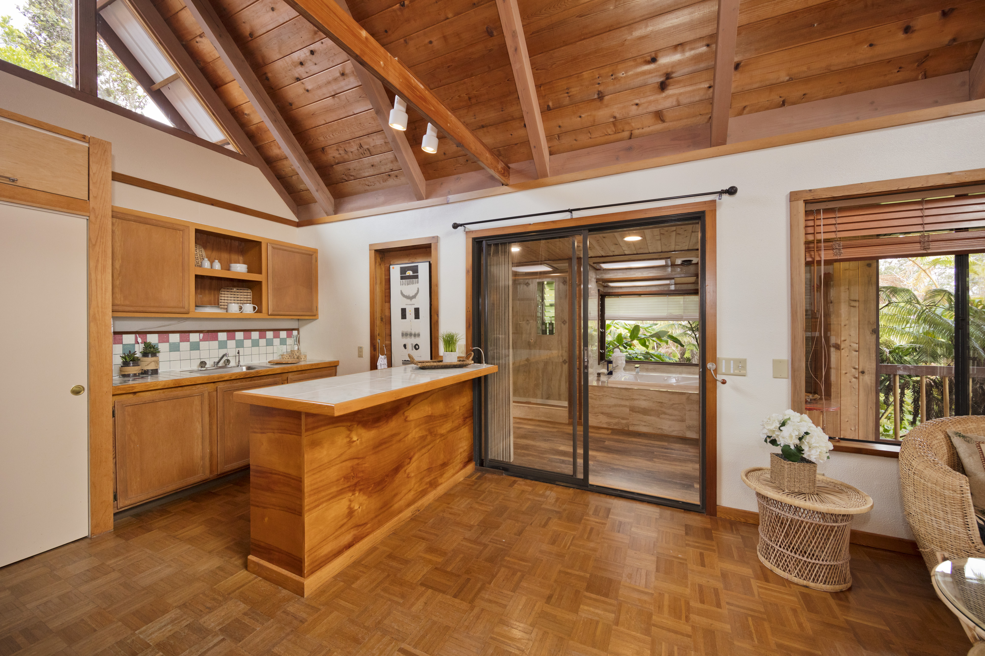 19-4245 Kekoa Nui Boulevard Volcano, HI 96785 - Photo 25 of 30 a large living room with stainless steel appliances wooden floor and furniture