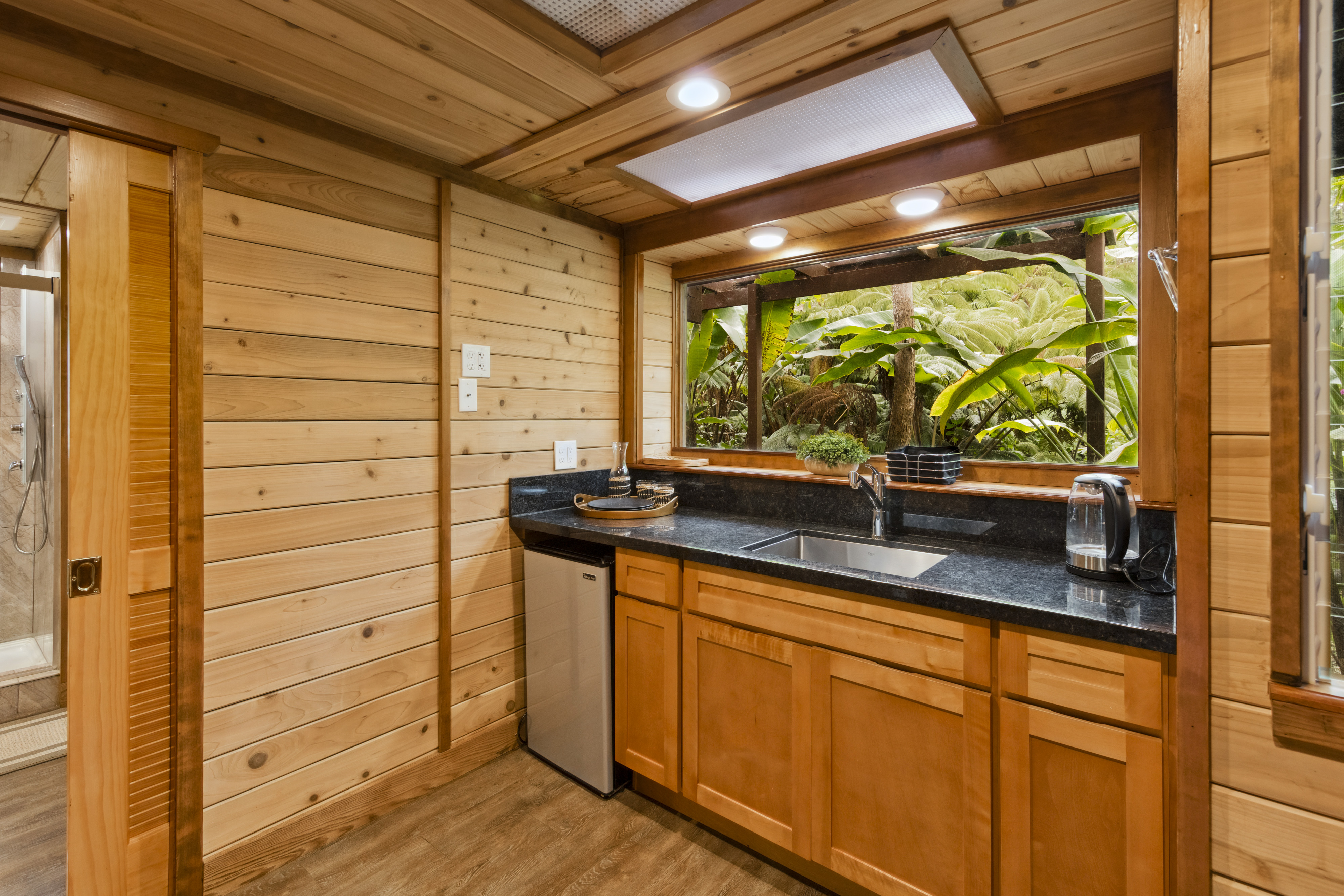 19-4245 Kekoa Nui Boulevard Volcano, HI 96785 - Photo 6 of 30 a bathroom with a sink and a large mirror next to a window