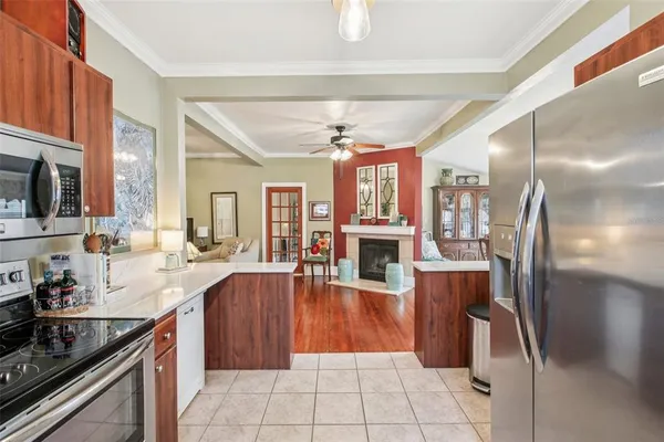 a kitchen with stainless steel appliances granite countertop a refrigerator a stove and a sink with cabinets