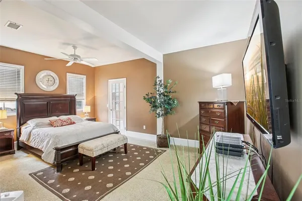 a bedroom with a bed and a flat screen tv