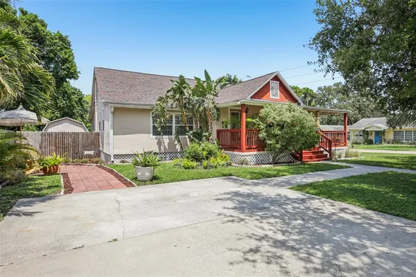 a front view of house with yard and green space