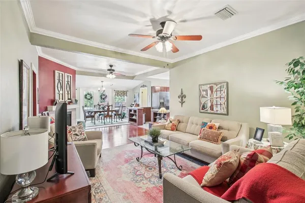 a living room with furniture and a chandelier