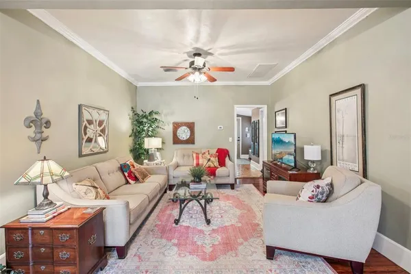 a living room with furniture and a chandelier