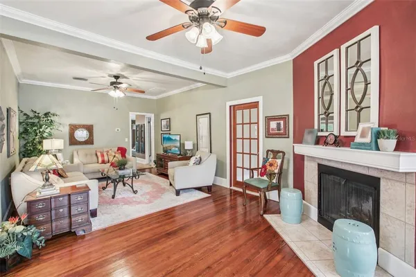 a living room with furniture a fireplace and a large window