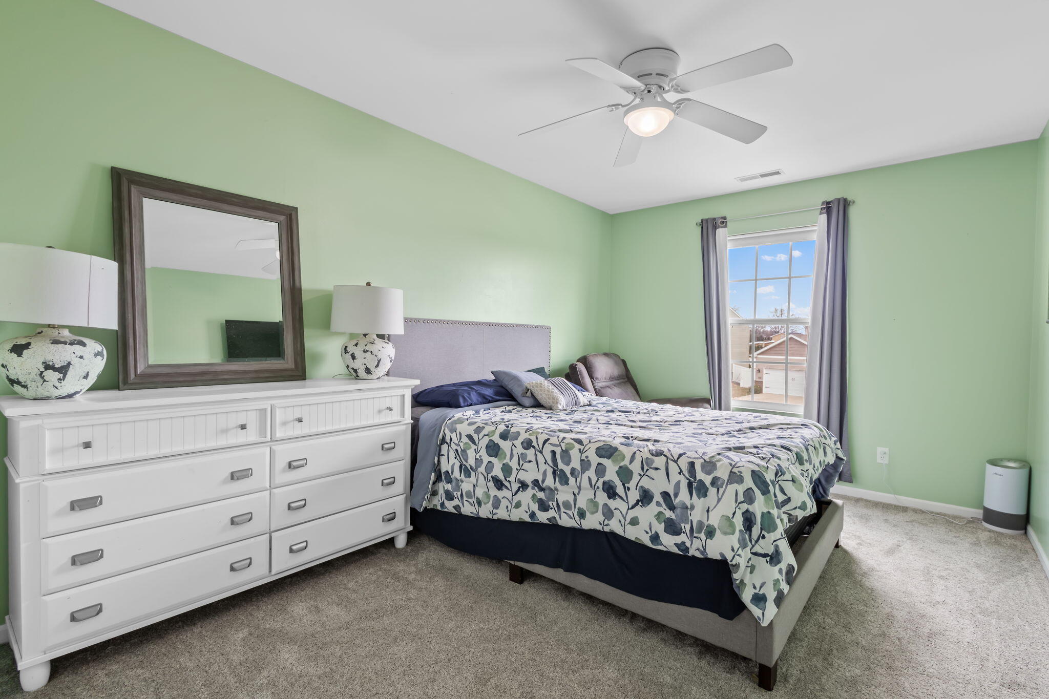 12938 Hayes Street Crown Point, IN 46307 - Photo 19 of 32 a bedroom with a bed a chandelier and a dresser